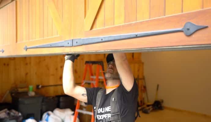 Fimbel technician installs wood garage door manufactured by C.H.I. Overhead Doors