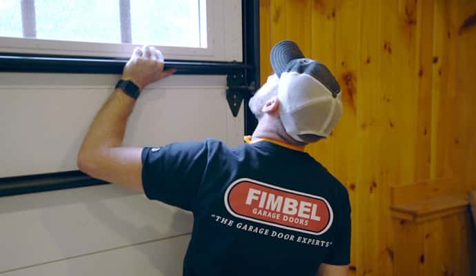 Fimbel service technician replaces section of vinyl garage door for a New Hampshire resident